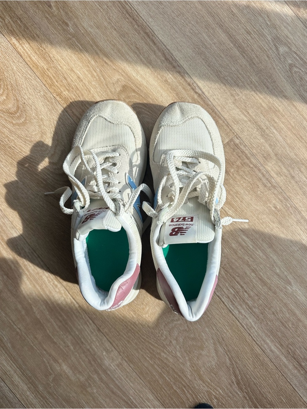 New Balance women’s 574 Cream Sneakers with Pink Heel Accents